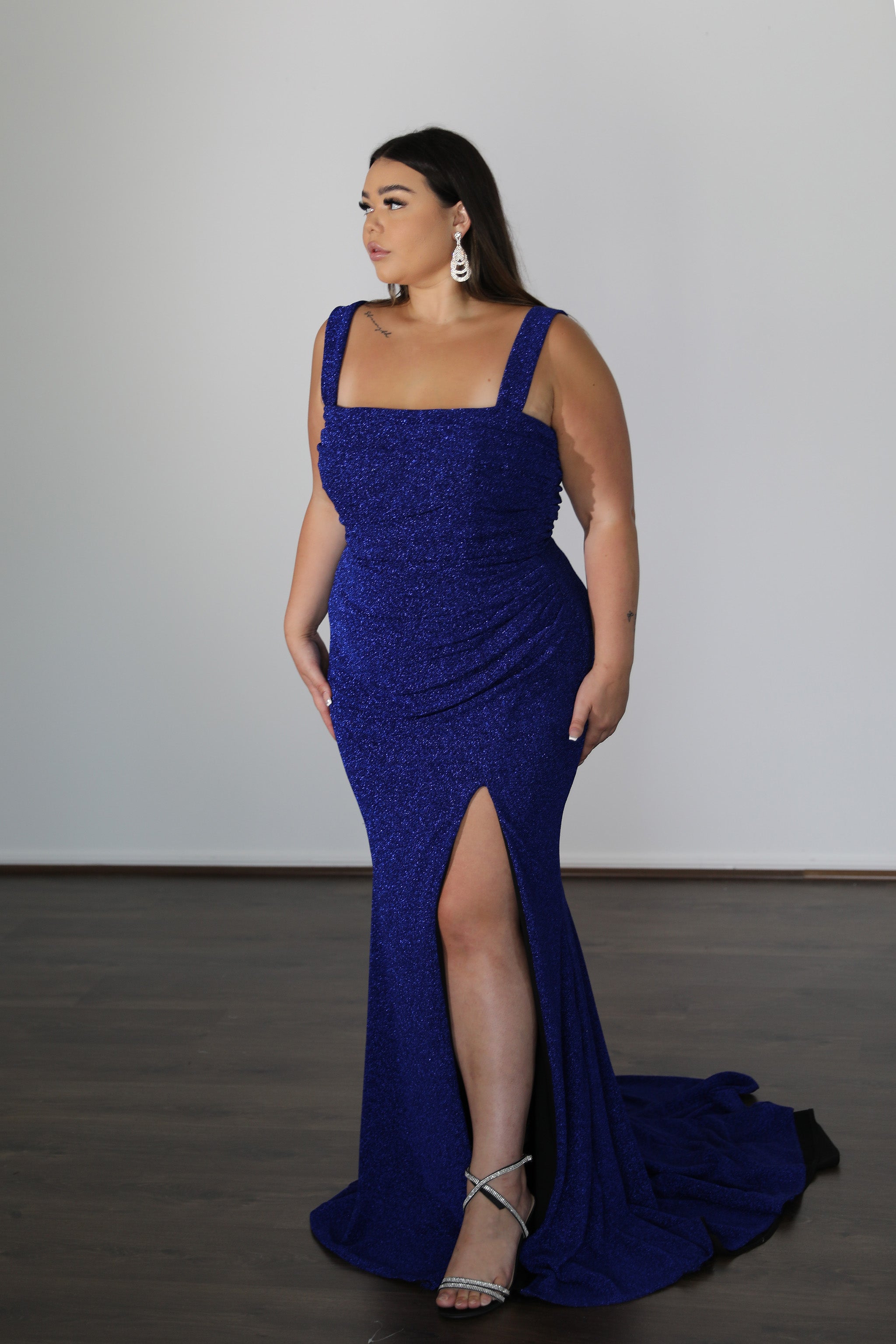 model wearing blue formal dress with straps and leg split