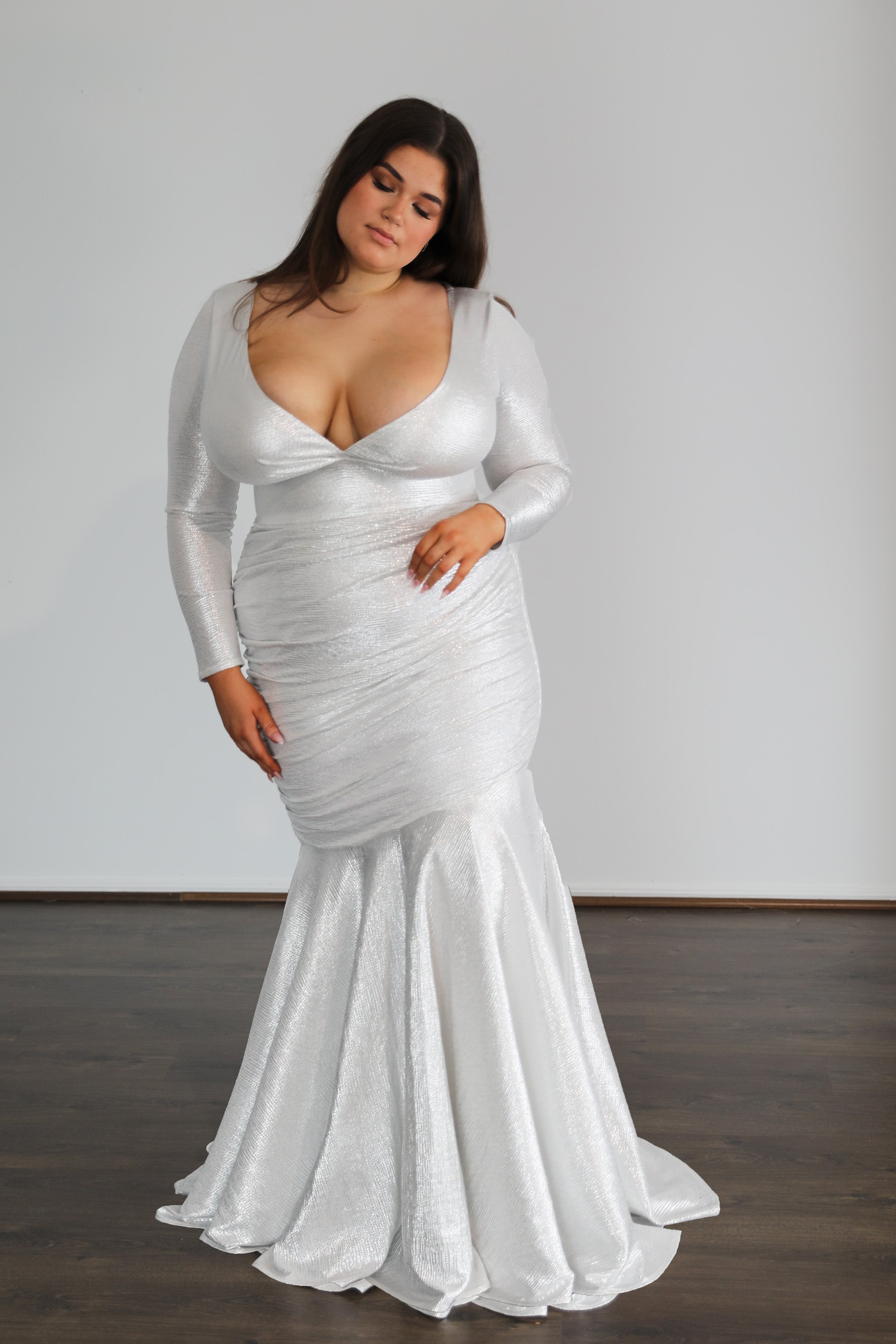 silver formal gown with long sleeves and low cut top